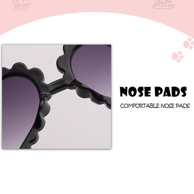 Kids heart-shaped sunglasses by Stevvex featuring cute, oversized design with flower details, blocking 90% of UVB and UVA rays.