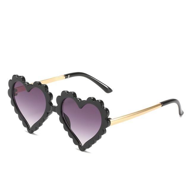 Cute heart-shaped sunglasses for kids by Stevvex, featuring oversized design and flower details, offering UV protection.