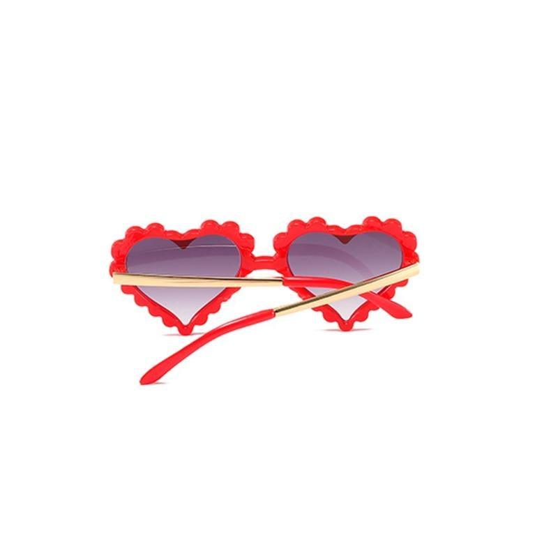 Kids' heart-shaped sunglasses by Stevvex with cute over-sized design, featuring flower and love details, UV protection, and a fashionable look.
