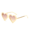 Kids heart-shaped sunglasses by Stevvex with colorful flower design, oversized style, and UV protection for children.