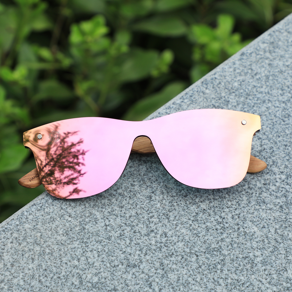 Papago Coral Ventures sunglasses with handmade recycled wooden frames, featuring leaf designs and a stylish, eco-friendly look.