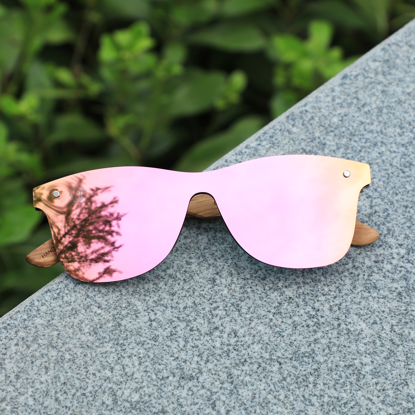 Papago Coral Ventures sunglasses with handmade recycled wooden frames, featuring leaf designs and a stylish, eco-friendly look.