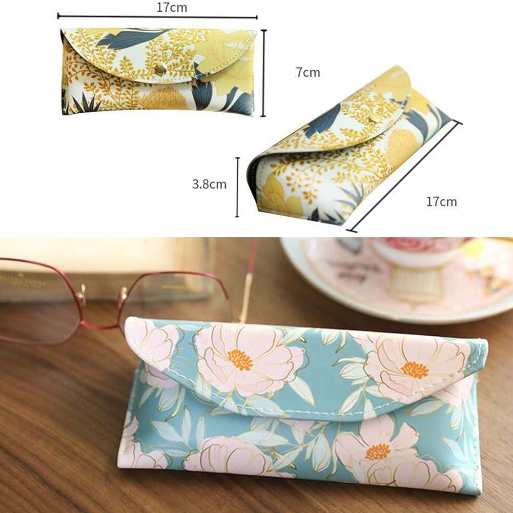 Blue flower-patterned Berry Charmz eyeglass case shown with zipper closure and soft interior for eyewear protection.