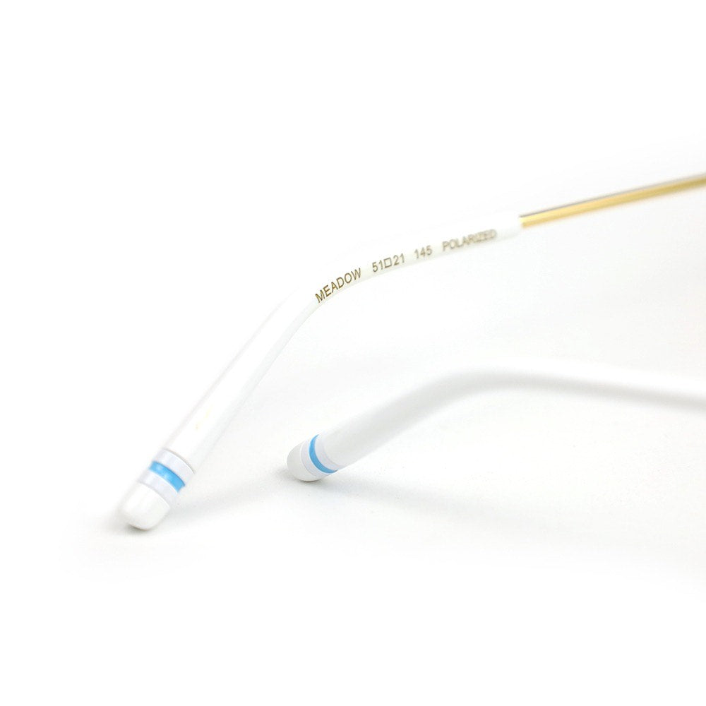 Out East Eyewear Meadow sunglasses with round tinted lenses and sleek black frames on a white background.