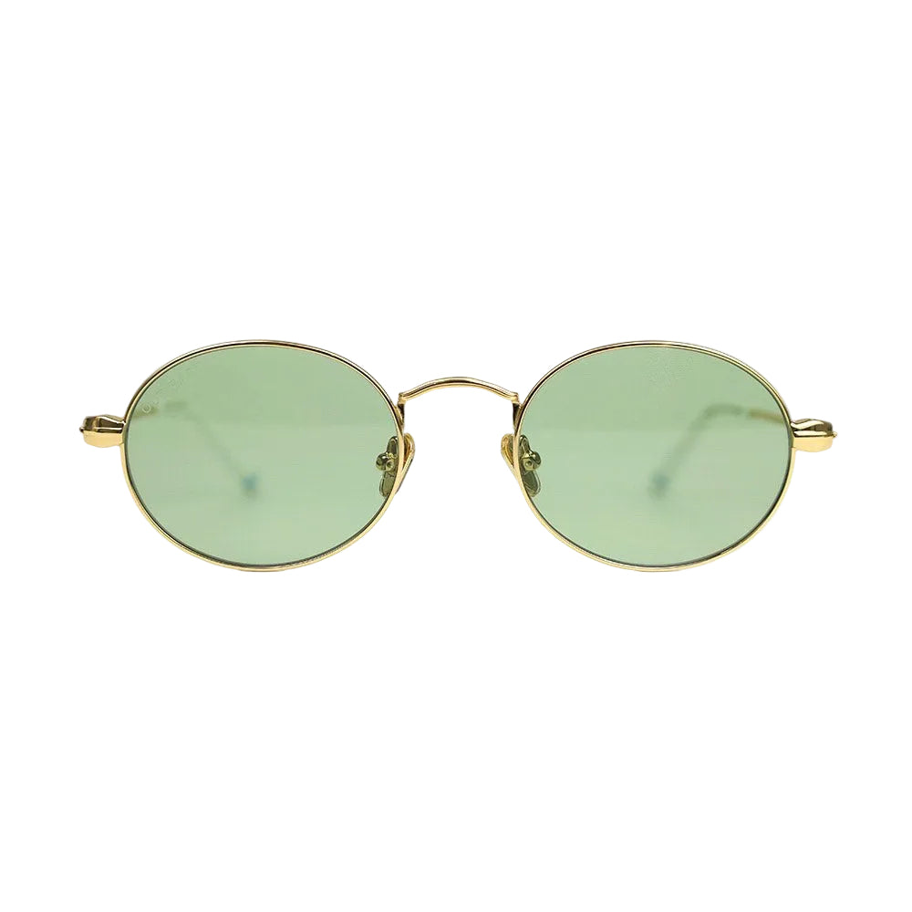 Out East Eyewear Meadow sunglasses with round frames and tinted lenses, resting on a wooden surface.