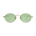 Out East Eyewear Meadow sunglasses with round frames and tinted lenses, resting on a wooden surface.