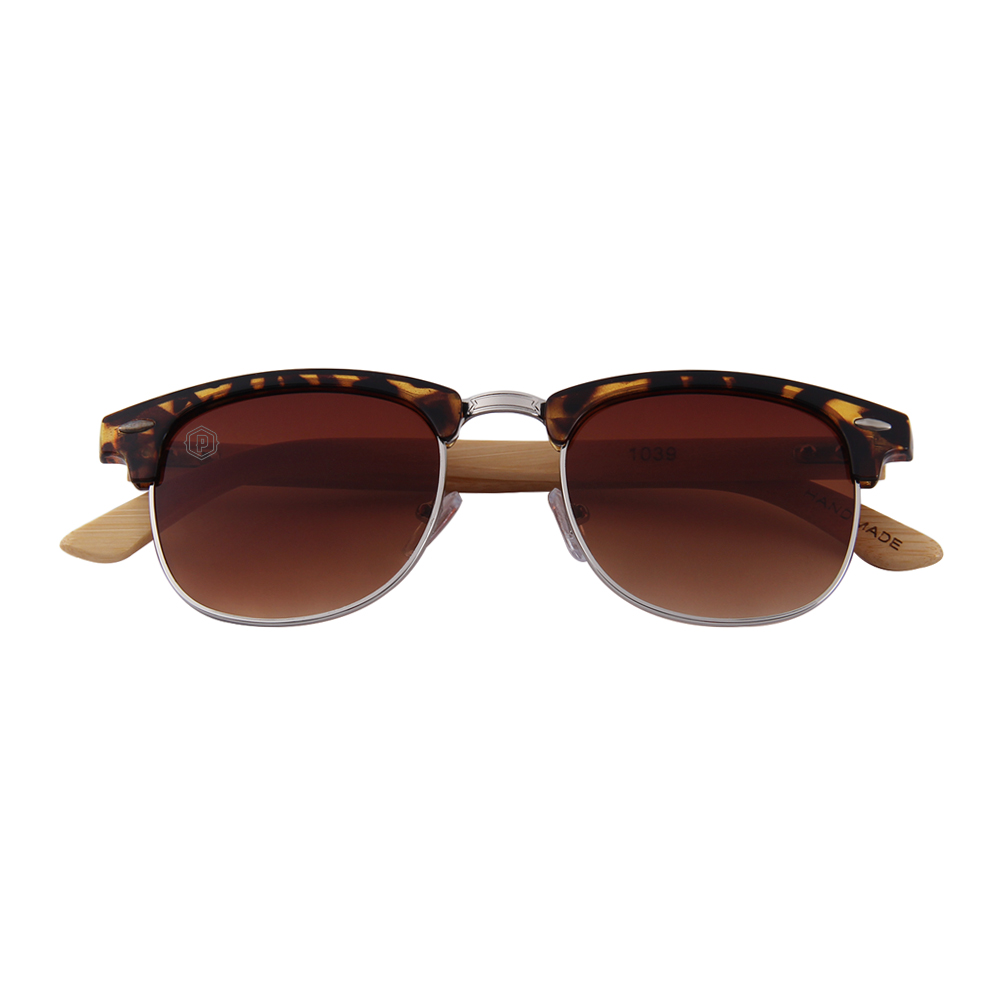 Papago Tortoise Apaches sunglasses made from handmade recycled wooden frames, laying down with arms crossed.